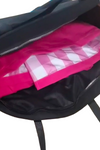 An open black lightweight looselyboho “The One” Waterproof Travel Bag reveals its contents, showing a pink and white striped item, possibly a bag or clothing, inside. The bag is unzipped, displaying the pink item clearly against the dark inner lining and an internal pocket—ideal for the sophisticated traveler.