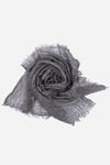 A crumpled, delicate gray Lightweight Linen Scarf with fringed edges from looselyboho laid out against a white background. The texture, made from ultra-breathable linen, appears soft and slightly sheer, with a somewhat wrinkled and flowing appearance that exudes artisanal charm.