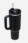 A black, vacuum-insulated looselyboho Indestructible Travel Cup with a large handle and a lid featuring a movable plastic straw. The bottom is narrower than the top, allowing it to fit in a car's cup holder.