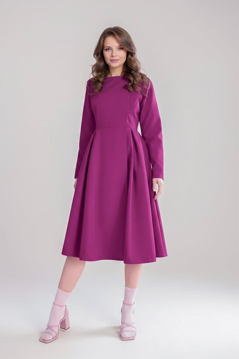A woman with wavy brown hair wears a magenta dress under a looselyboho Water-Repellent Rain & Shine A-Line Hooded Raincoat, paired with light pink heeled sandals and ankle socks, standing against a plain, light background.